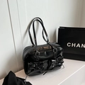 Glossy black patent leather bowling bag with twin bow pockets and white contrast stitching - Black