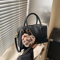 Black pebbled leather Boston bag with leopard heart charm and gold-tone hardware - Black with Pendant