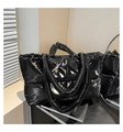 Detailed view of large black glossy down tote bag with plush padded texture and double handles - Black
