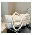 Detail of quilted puffer tote bag with glossy beige finish and padded handles - White