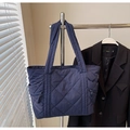 Detail of navy blue quilted puffer tote bag with side zipper and nylon texture - Navy Blue