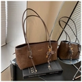 Brown suede tote bag with leather trim and gold key charm on a stack of books - Coffee (With Charm)