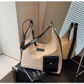 Detail of canvas tote bag with black leather pocket and elegant golden metal studs - Off White