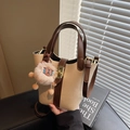 Beige and brown contrast bucket bag with metallic twist lock and plush charm accessory - Off-white (With Pendant)