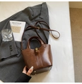 Vintage brown bucket bag with gold hardware and dual handles shown from a top view - Brown (Without Pendant)