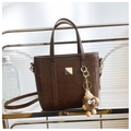 Dark brown leather tote bag detail with golden metal plate and plush bear charm - Brown with Pendant