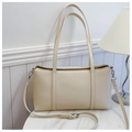 Detail of a creamy white lychee leather shoulder bag on a white marble table - Off-white