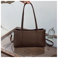Detailed close-up of dark brown pebble leather texture on a rectangular tote bag - Coffee