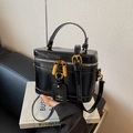 Elegant black leather box handbag with gold hardware and adjustable strap detail - Black