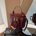 Deep red box-style handbag in glossy leather with adjustable strap and retro bronze hardware - Burgundy