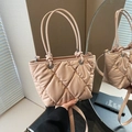 Quilted nude pink bucket bag with knot handles and crossbody strap in elegant style - Pink