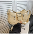 Close-up of beige faux leather shoulder bag with silver buckle and zipper pockets - White