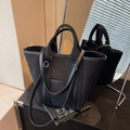 Large black canvas tote bag with leather trim shown with a creative mirror reflection - Black