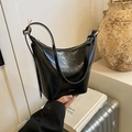 Glänzende schwarze Hobo-Tasche aus Lackleder mit Knitteroptik und silbernen Metallteilen - Schwarz