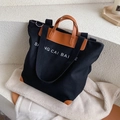 Borsa tote nera in tela con manici in pelle marrone e tracolla regolabile per donne - Nero