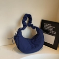 Dark blue quilted crescent bag with ruffled strap and durable nylon finish - Blue