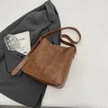 Vintage brown leather bucket bag for women featuring a retro textured finish and wide strap - Khaki