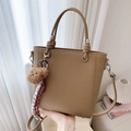 Khaki pebbled leather bucket bag with plush bear charm and detachable long strap - Khaki
