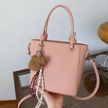 Pink lychee grain leather bucket bag with teddy bear charm and woven tassel detail - Pink