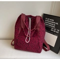 Detail of burgundy leopard print drawstring tote bag with wide straps on white background - Burgundy