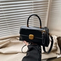 Glossy black patent leather crossbody bag with elegant gold hardware and top handle - Black