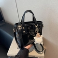 Glossy black shoulder bucket bag with golden studs and cute plush monster charm - Black With Pendant