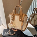 Beige bucket bag with caramel trim, brand logo, and cute plush charm detail - Cream White With Pendant