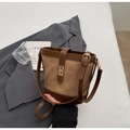 Detailed close-up of a retro canvas bucket bag with brown leather trim and gold lock - Coffee No Charm