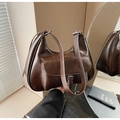 Detailed view of deep brown hobo bag with adjustable strap and front pocket buckle - Brown