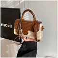Close-up of retro color-block handbag featuring wave-edge flap and golden twist lock - With Charm / White