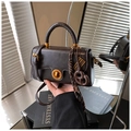 Deep brown leather crossbody bag with golden clasp and decorative bow detail - With Charm / Black