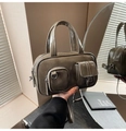 Detail of dark olive bowling bag featuring twin front pockets and polished PU leather texture - Elephant Gray