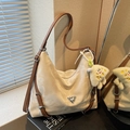 Chic cream hobo bag with brown leather straps and cute plush pendant in natural light - Cream White With Pendant