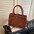 Brown leather crossbody tote bag with horseshoe buckle and textured finish - Brown