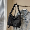 Black nylon crossbody bag with cloud-style ruched strap and front buckle pockets - Black