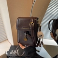 Dark brown leather crossbody phone bag with vintage texture and plush eye charm - Coffee with Pendant