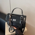 Classic black faux leather handbag with silver twist lock and decorative charms - With Charm / Black