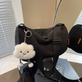 Black corduroy cylindrical crossbody bag with wide strap and plush cloud charm - With Charm / Black
