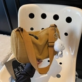 Ginger yellow corduroy cylinder bag with wide strap and cloud pendant on white chair - With Charm / Brown