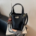 Glossy black patent leather bucket bag with top handle and cute teddy bear charm - Black