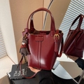 Deep red patent leather bucket bag with top handles and cute brown bear pendant - Burgundy