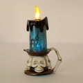 Macro view of Halloween skull base LED candle with blue glitter and castle silhouette - Castle Style