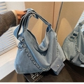 Macro detail of blue denim tote bag with decorative silver chain and mini coin pouch accessory - Light Blue