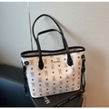 Macro view of white tote bag with bear pattern print and gold logo detailing - White and Black