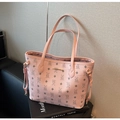 Close-up of pink tote bag featuring lychee grain texture and bear pattern with brand plate - Pink