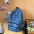 Blue denim backpack with white embroidery featuring multi-pocket functional design - Dark Blue