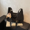 Black nylon hobo dumpling crossbody bag with adjustable strap and cute brown plush charm - Black