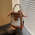 Denim and brown leather bucket bag with decorative silk scarf and gold hardware accents - Blue