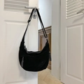 Black suede hobo bag with moon shape and woven pendant detail on white door handle - Black