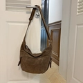 Dark brown suede hobo bag in half-moon shape hanging on a white door handle - Dark Coffee